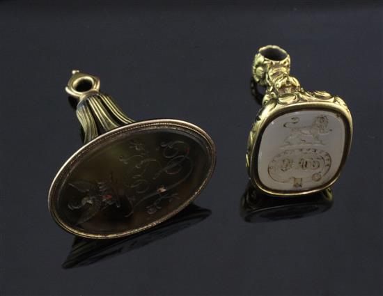 Two early 19th century gold overlaid and carnelian set fob seals, largest 1.75in.